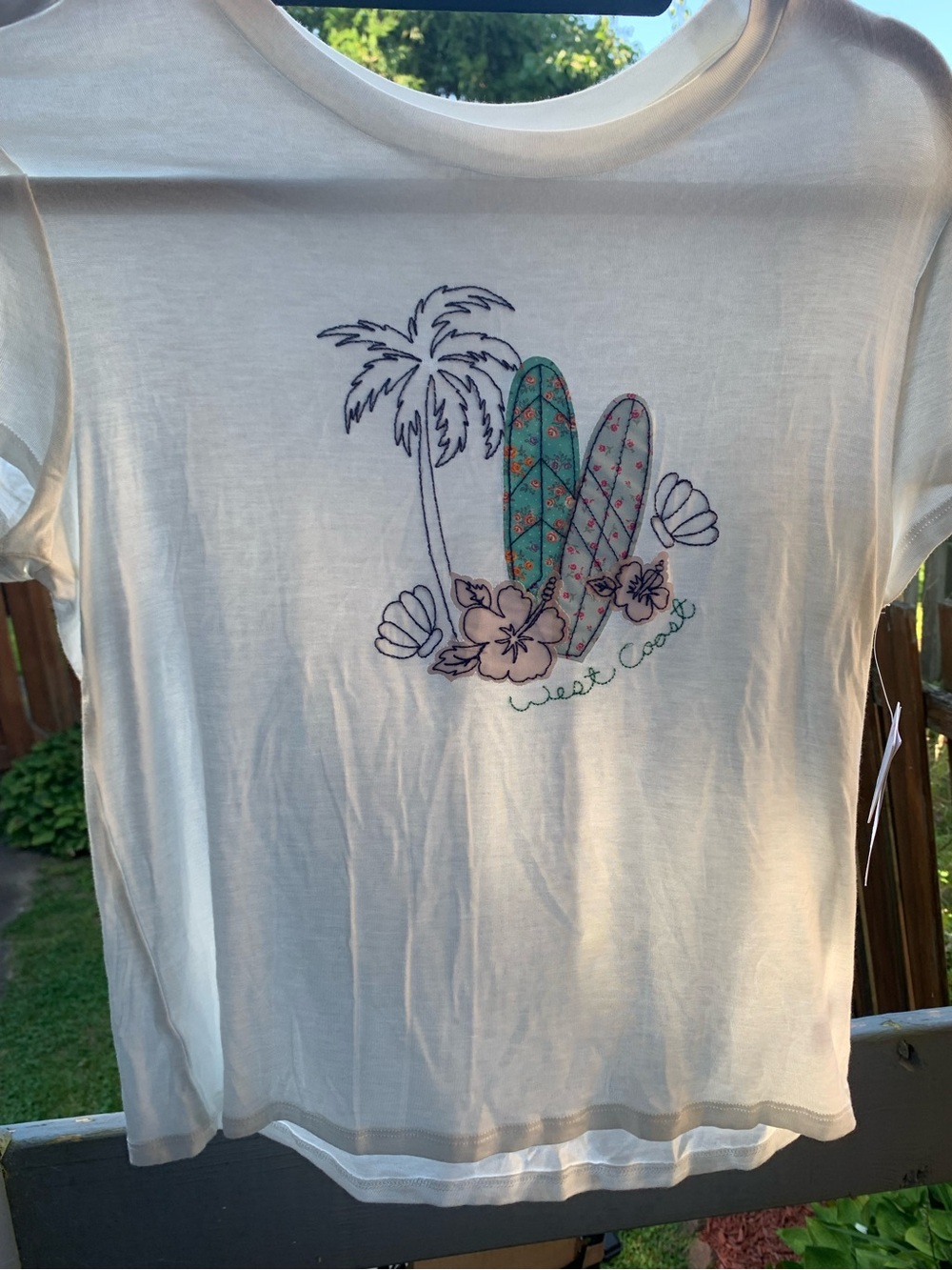 Rebellious One Cream Short Sleeve Tee with Teal & Pink Surfboard Embroidery